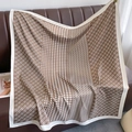 Detailed view of the houndstooth and chain pattern on a large brown silk scarf - One Size / Coffee
