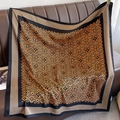 Detail of vintage square silk scarf with geometric patterns draped on a leather sofa - 90*90cm / Orange Khaki