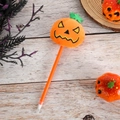Halloween pumpkin gel pen with orange plush head and funny face on wooden background - Orange Barrel Angry Pumpkin
