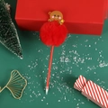 Detail view of a Christmas gingerbread man pen with a red plush pom pom on a festive background - Gingerbread Man / Red