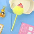 Detail of creative yellow pompom pen with cupcake topper and sweet motif on blue background - Yellow