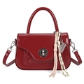 Glossy red faux leather handbag with silver twist lock and woven charm detail - Red