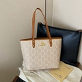 Beige tote bag with brown leather handles and gold kangaroo logo on a white textile - CC Beige