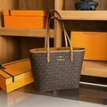Brown tote bag with KMT letter print and gold kangaroo logo on a wooden shelf - MT Coffee