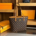 Deep brown tote bag with classic letter pattern and gold kangaroo logo on store shelf - Letter K Coffee