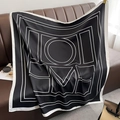 Detailed view of silk square scarf with LOVE letter print on a dark leather background - Large / Black