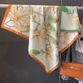 Vintage magnolia print silk scarf with orange green borders hanging in a fashion setup - Orange Edge (HS-2-Orange Edge) / 90*90cm
