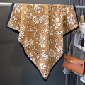 Detailed close-up of a floral print caramel silk scarf styled with professional outfits - Khaki (HSM-35)
