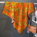 Macro view of orange square silk scarf featuring yellow floral prints and dark brown borders - Orange (HSM-35)