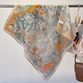 Exotic orange silk scarf with tiger and landscape print hanging on a rack for display - Illustrative Print Beige Edge (FW-77) / One Size