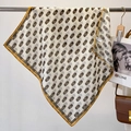 Silk feel square scarf with chain print and yellow border hanging in a stylish setup - 68x68cm / Beige (FW-84)