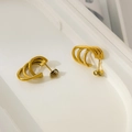 Detail view of gold-plated triple-layered curved stud earrings with a 3D arc design - Triple Layer Line