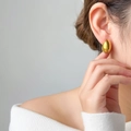 Close-up of elegant gold oval hoop earrings with a polished mirror finish on model - Hollow Oval Egg Shape