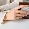 Detail shot of golden twisted cable open bangle and ring set on person's wrist - Twist Cable Opening Ring