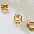 Detailed view of 18K gold plated titanium rings featuring large zircon and open band design - US 6 / Large Round Zircon