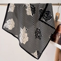 Close-up of lightweight houndstooth and floral scarf draped on a display rod - 68*68cm / Black Beige