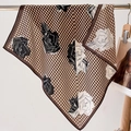 Close-up of houndstooth silk scarf with rose floral print hanging on a metal rod - 68*68cm / Coffee Edge