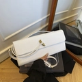 White snake skin embossed evening bag with gold knot buckle and shoulder strap - White