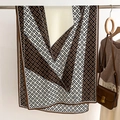 Detail of elegant geometric silk scarf in brown and black draped on a metal stand - 178X66CM / Coffee
