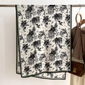 Detailed drape of vintage building print scarf with dark green hem on a metal rack - 66*178cm / Cream White (FSM-22)