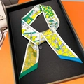 Detail of multi-color printed silk twilly scarf with abstract patterns on black display tray - 5*85cm / Yellow