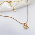 Macro detail of gold snake chain with square cat eye stone pendant and K18 tag - Gold - Square Cat Eye Stone Style