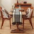 Bohemian woven table runner and matching pillows with black tassels in a cozy dining room - 30x50cm / Black Spliced Off-white