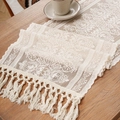 Elegant beige lace table runner with floral patterns and tassels on a wooden table - XS / Off White