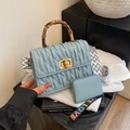 Light blue pleated bag with bamboo handle, quilted texture and geometric strap - Blue