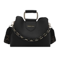 Black pebbled leather tote with metal handle, gold chain decor and patterned shoulder strap - Black