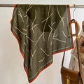 Close-up of a green silk scarf with white lines and orange edges on a metal rack - 68*68cm / Army Green