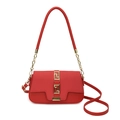Elegant red saddle bag for women with gold buckle and textured leather strap - Red
