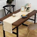 Camino de mesa beige minimalista con borlas sobre mesa de comedor de madera oscura - 30x160cm / Beige