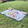 Waterproof blue and white checkered outdoor picnic mat on grass for family outing - Light Blue