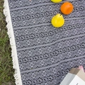 Close-up of bohemian picnic blanket with tribal patterns and tassels on grass - 100*150cm