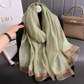 Elegant silk-like striped scarf with metallic fibers shown in a luxury lifestyle setting - Fruit Green