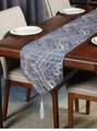 Close-up of blue marble wave jacquard table runner with delicate white tassel fringe detail - 35x150cm / Blue