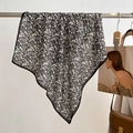 Detail of floral neck scarf featuring delicate black edging and soft chiffon texture - Black