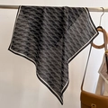 Detail of black and white square scarf with letter print on a minimalist metal rack - 68*68cm / Black
