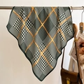 Classic houndstooth silk scarf with orange stripes displayed on a metal hanger with bags - Army Green