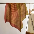 Detail of striped geometric square scarf draped on a metal rack with lifestyle outfit - Burgundy / 68*68cm