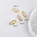 Set di quattro anelli a catena placcati in oro con vari motivi geometrici vuoti - US 6 / Stile A