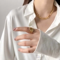 Close-up of gold irregular texture ring and layered necklace on white silk shirt - US 6 / Tin Foil Style