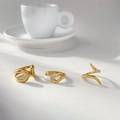 Three 18K gold plated rings including abstract snake and hug designs on white surface - US 6 / Hollow Open Style