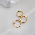 Dettaglio di anelli d'oro interconnessi con scanalature strutturate e finitura lucida moderna - US 7 / Triplo Anello Oro
