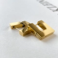 Detailed close-up of polished gold rectangular geometric hoop earrings with mirror finish - Square Style / Gold