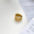 Detailed view of wide double-layer gold ring on minimalist vintage paper background - US 6 / Layered Style