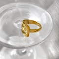 Macro shot of polished gold irregular ring featuring unique cutout buckle detail - US 6 / Hollow Style