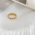 Close-up of thin 18K gold band with colorful stones in starburst engravings - US 6 / Multi-color Zirconia Style