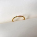 Macro shot of 18K gold band with colorful rainbow zircon stones on white paper - US 6 / Rainbow Pave Style